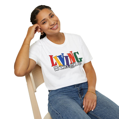 Person wearing a white t-shirt with colorful text "living single" sitting on a chair.
